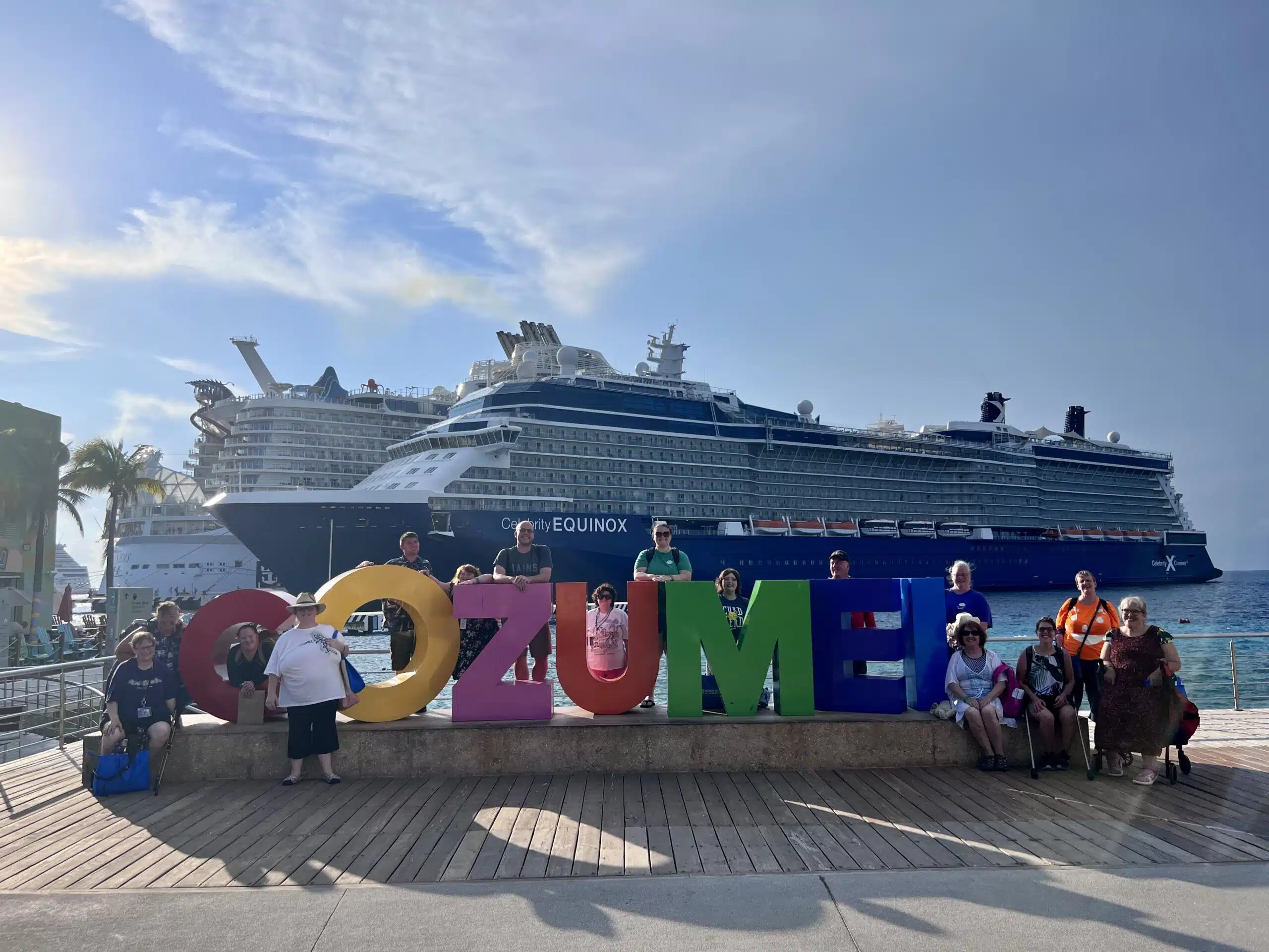Campers swim with dolphins in Cozumel on a travel trip!